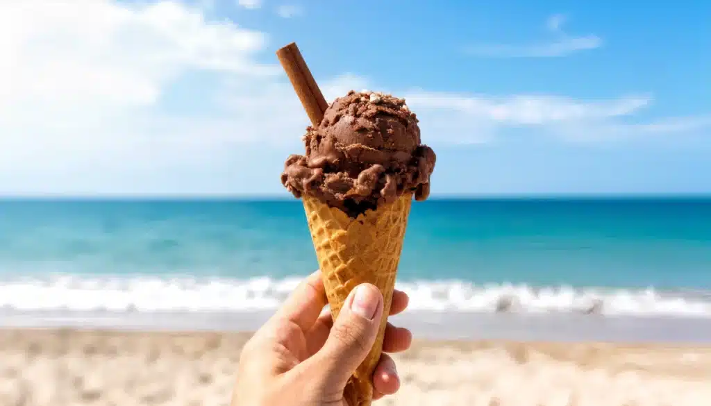 un cucurucho con helado de chocolate con una rama de canela